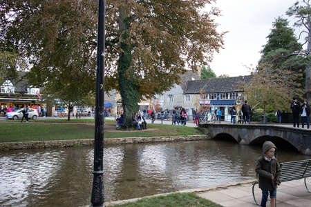 GLOUCESTERSHIRE, UNITED KINGDOM - Oct 19, 2019: A view of Bourton on the Water in Autumn, a typical Cotswolds villageのeditorial素材