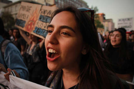 SANTIAGO, CHILE - Sep 27, 2019: In Santiago Chile Global strike for planet, students protesting during fridays for future. Hands and posters up to the sky,のeditorial素材