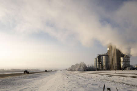 SEXSMITH, CANADA - Dec 21, 2019: A bank of fog limits driver's visibility at a busy intersection in northern Alberta. Local residents are concerned that it may be industry-caused.のeditorial素材