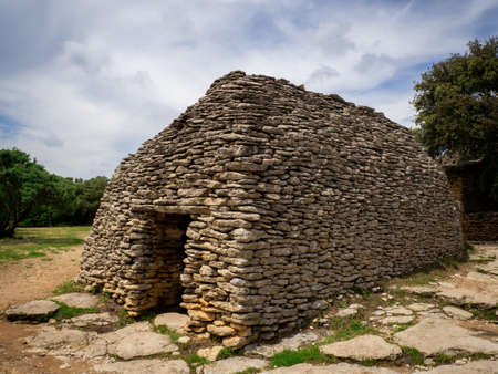 An old rock made house under a blue cloudy skyのeditorial素材