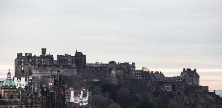 A beautiful shot of the Castle Edinburgh in the distance with a cloudy sky in the backgroundのeditorial素材