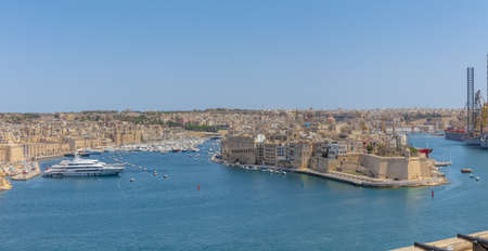 VALLETTA, MALTA - Jul 14, 2017: The Port of Valletta with boats on it under a blue sky and sunlight in Maltaのeditorial素材