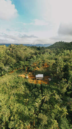 Beautiful Aerial Drone Shot View of a House Cabin on the top of Countryside Mountain Hill Village in the Philippines. Summer Holiday Nature Forest.のeditorial素材
