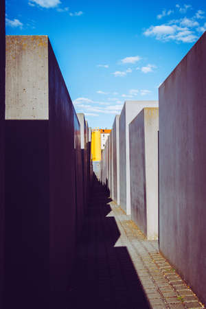 A vertical shot of the Holocaust memorial in Berlin, Germany from the inside with shadows reflecting the silhouette on the groundのeditorial素材