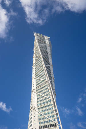 A low angle view of the Turning Torso under a blue sky and sunlight in Malmo in Swedenのeditorial素材