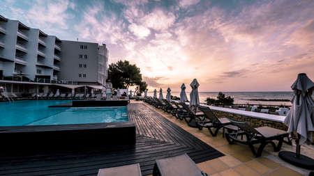 A hotel with a pool next to the beachのeditorial素材