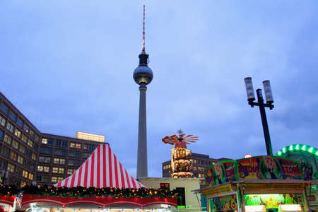BERLIN, GERMANY - Nov 29, 2019: BERLIN, GERMANY- 29 NOVEMBER, 2019: Decorated booths and christmas lights at Alexanderplatz Christmas Market. Berlin TV Towerのeditorial素材