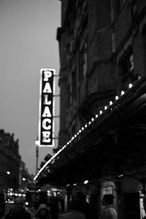 LONDON, UNITED KINGDOM - Apr 12, 2018: Monochrome string of lights at dusk in front of a theatreのeditorial素材