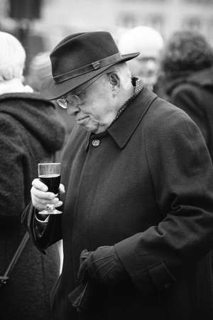 BERN, SWITZERLAND - Dec 06, 2017: A greyscale picture of Christoph Blocker drinking wine during the SVP party in Bernのeditorial素材