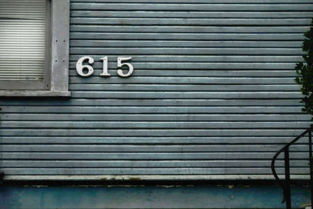 PORTLAND, UNITED STATES - Sep 07, 2019: The white wooden wall and the window on a house by the sidewalkのeditorial素材