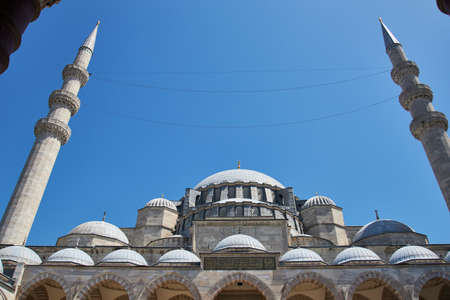 A low angle shot of a mosque with Turkish writing on it and a clear blue sky in the background in Istanbulのeditorial素材