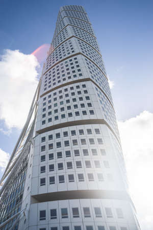 A low angle view of the Turning Torso under a blue sky and sunlight in Malmo in Swedenのeditorial素材