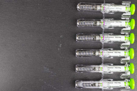 LEEDS, UNITED KINGDOM - Jan 27, 2019: Array of Tocilizumab injection right side of the frame on a slate background.のeditorial素材