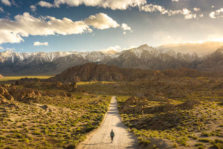 A lonely person walking on a pathway in Alabama hills in California with Mount Whitney in the backgroundのeditorial素材