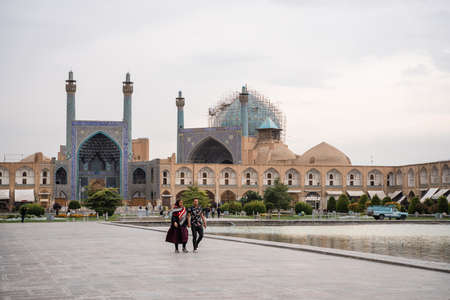 ESFAHAN, IRAN - Oct 22, 2019: Two Iranian people sitting on the royal square. Isfahan, Iran - October 2019のeditorial素材