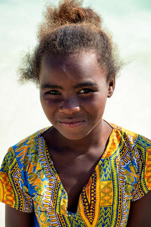 AMBATOMILO, MADAGASCAR - Aug 15, 2019: A girl on the beach with the good dressのeditorial素材