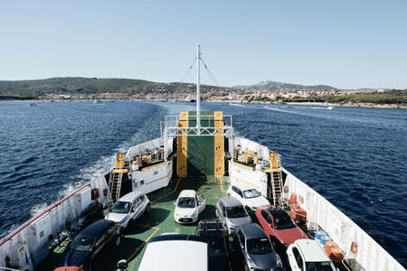 PALAU, ITALY - Aug 20, 2019: Horizontal shot of the view from the upper deck of cars embarked on a ferry boat leaving Palau in Sardinia, Italyのeditorial素材