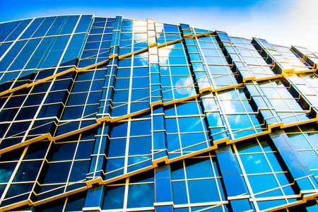 SANTIAGO DE COMPOSTELA, SPAIN - May 14, 2018: Glass business office building facade, reflection of...