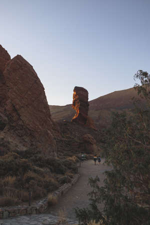 A scenery of people walking towards the mountains looking for adventures