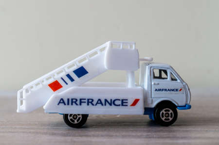 POZNAN, POLAND - Jun 28, 2020: Welly Airfrance airport truck on a wooden surface