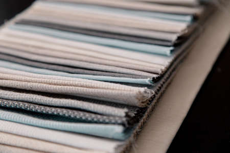 A lot of colorful folded textiles in a tailors studio