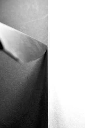 A vertical grey scale shot of a knife on a black and white surface captured from a high angleの写真素材
