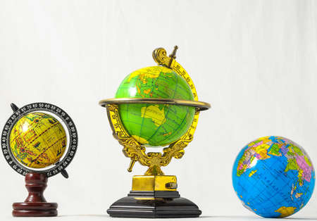 A landscape shot of three different globe models with a white color in the backgroundの写真素材