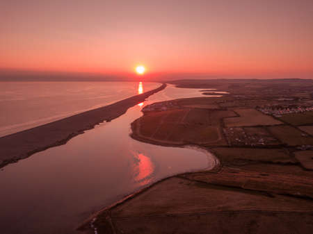 The sunset over the Fleet in Weymouth, Dorset, UKの写真素材