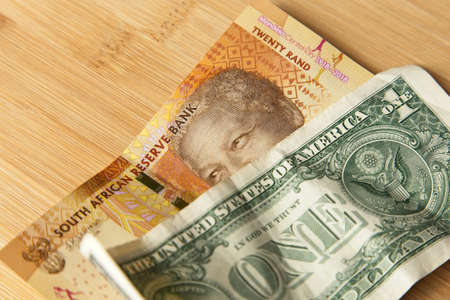 A high angle closeup shot of a some cash on wooden surface