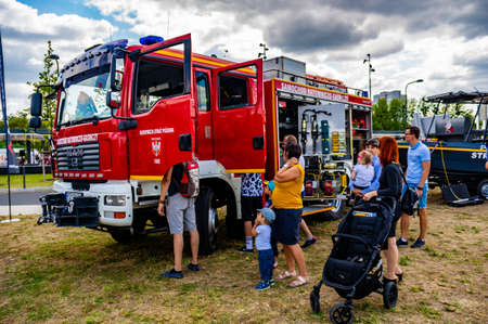 POZNAN, POLAND - Jun 03, 2019: People standing by a exposition fire truck during a event.
