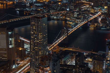 A high angle timelapse shot of bridges over the water in the middle of city buildingsの写真素材
