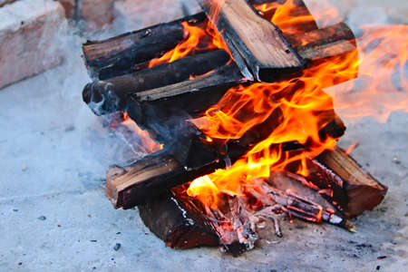 A high angle shot of woods burning in a bonfire