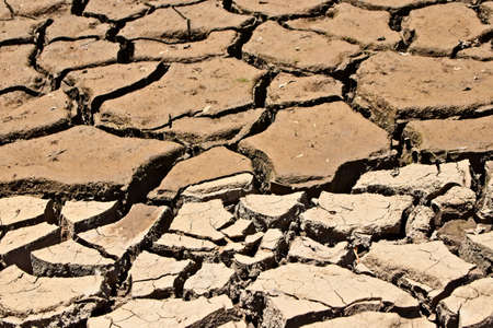 A high angle shot of the dried and cracked muddy groundの写真素材