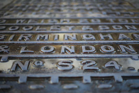 A selective focus shot of the writing "London" on a steel plateの写真素材