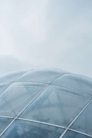 A closeup shot of a glass dome framed with white metals