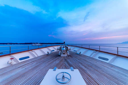 A beautiful shot from the boat of the sea under a cloudy blue and purple skyの写真素材