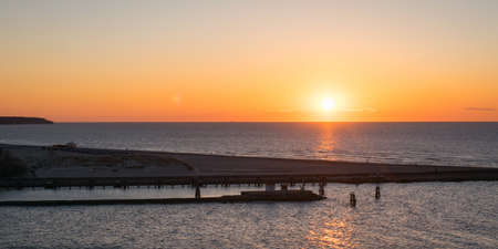 A beautiful scenery of the sunset reflecting on the seaの写真素材