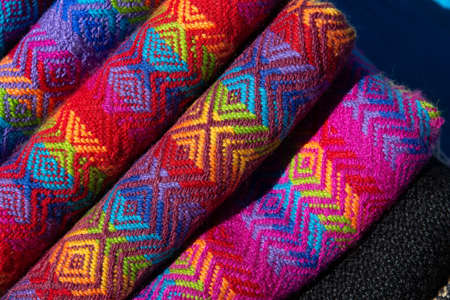 A closeup shot of rolled fabrics with colorful and unique designsの写真素材