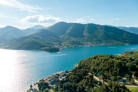 A high angle shot of buildings near the forested mountains in Kotor, Montenegroの写真素材