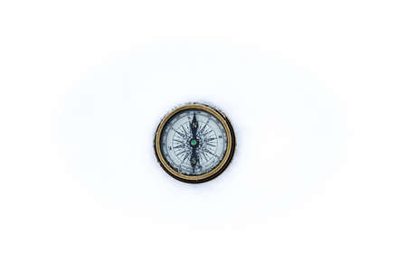 A compass for directions with a golden outer ring on a white backgroundの写真素材