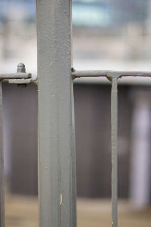 A vertical shot of a metal railing with a blurred backgroundの写真素材