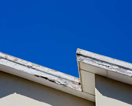 A low angle shot of a white roof touching the clear sky