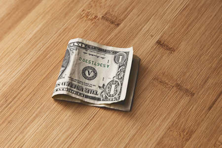 A high angle closeup shot of an American dollar bill on a wooden surface