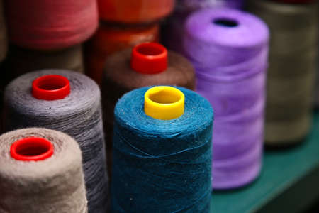 A high angle shot of yarns of thread with different colors in a shopの写真素材