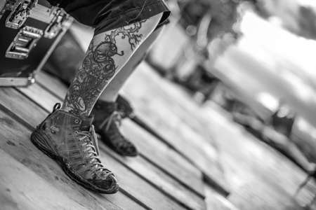 ALBA, ITALY - Jul 29, 2014: black and white detail of a tattoo on a legの写真素材