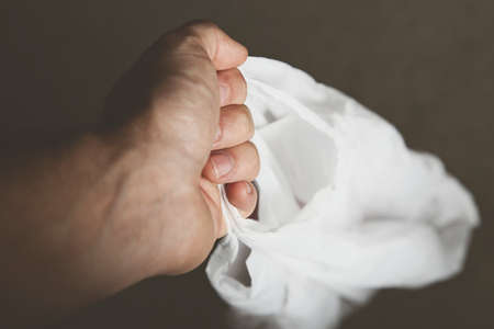 A selective focus shot of a person holding a grocery bag