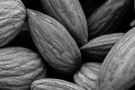 A greyscale closeup shot of a lot of almonds - great for a monochrome background