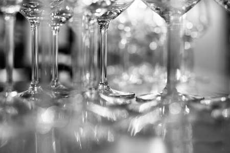 A selective focus shot of the stem of a glass wine with a blurred backgroundの写真素材