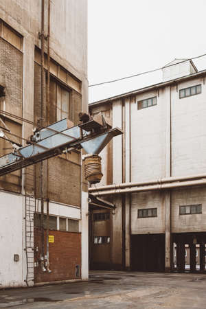 A vertical shot of a white building behind a metal architectural instrumentの写真素材