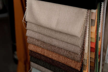 A lot of colorful folded textiles in a studio